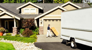 Moving truck in driveway of house