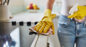 Hand in rubber glove cleaning banister