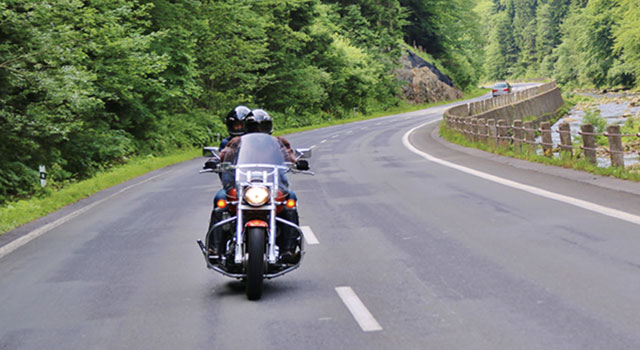 motorcycle with two riders on open road