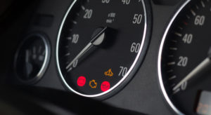 close up of blinking red light on car dashboard