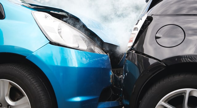 a fender bender with a blue and grey car