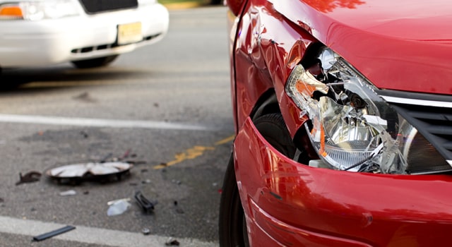 dented red car