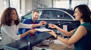 Couple buying a car at new car dealership