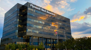 Outdoor building with Plymouth Rock Assurance sign