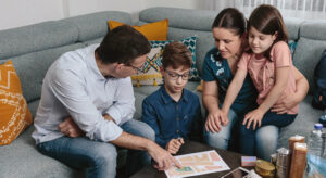 Family sitting in living room reviewing escape route in case of fire