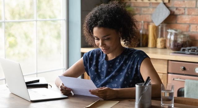 Woman reviewing a document at a table